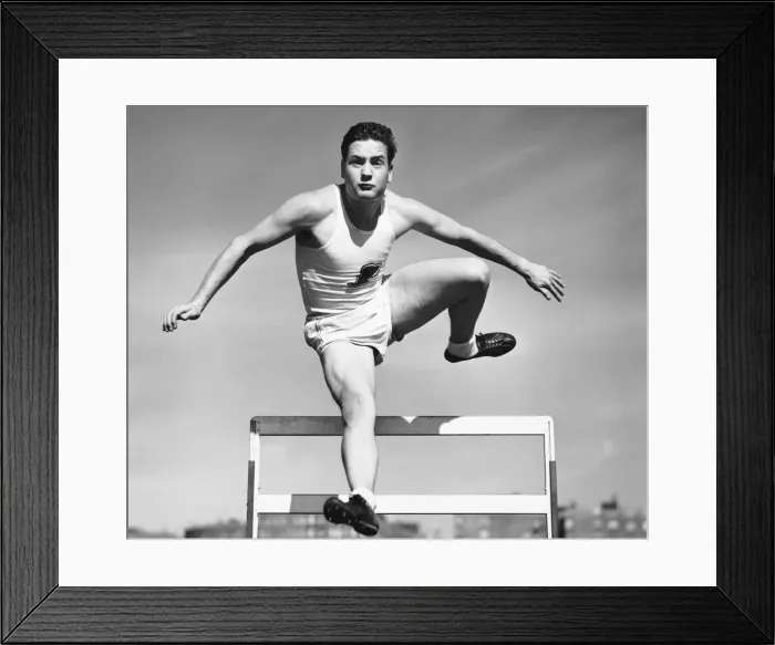 Framed Print : Man jumping over hurdle Framed Print : Man jumping over hurdle