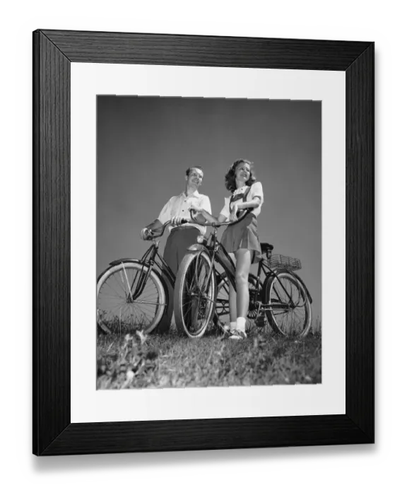 Framed Print : Couple standing with bicycles Framed Print : Couple standing with bicycles
