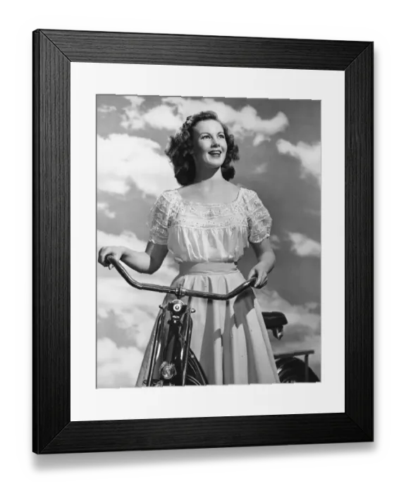 Framed Print : Woman standing with bicycle Framed Print : Woman standing with bicycle