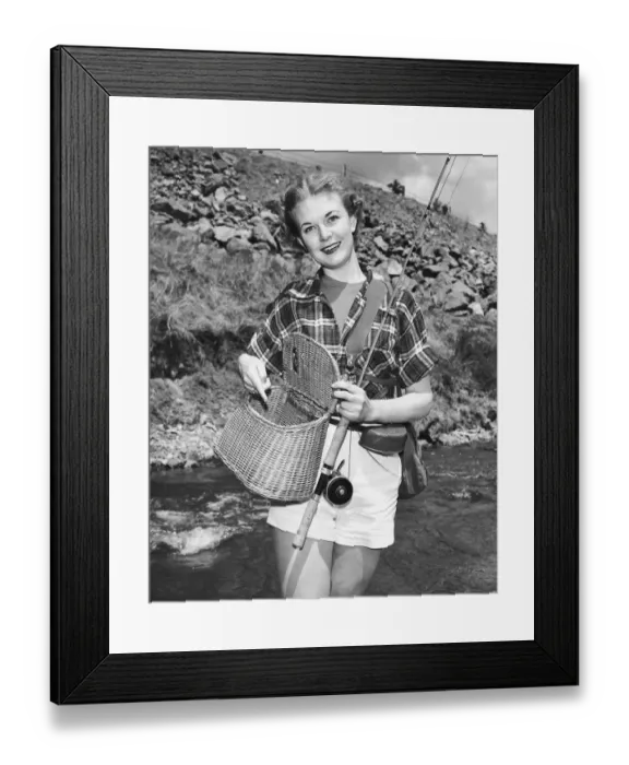 Framed Print : Woman holding creel and fishing rod Framed Print : Woman holding creel and fishing rod