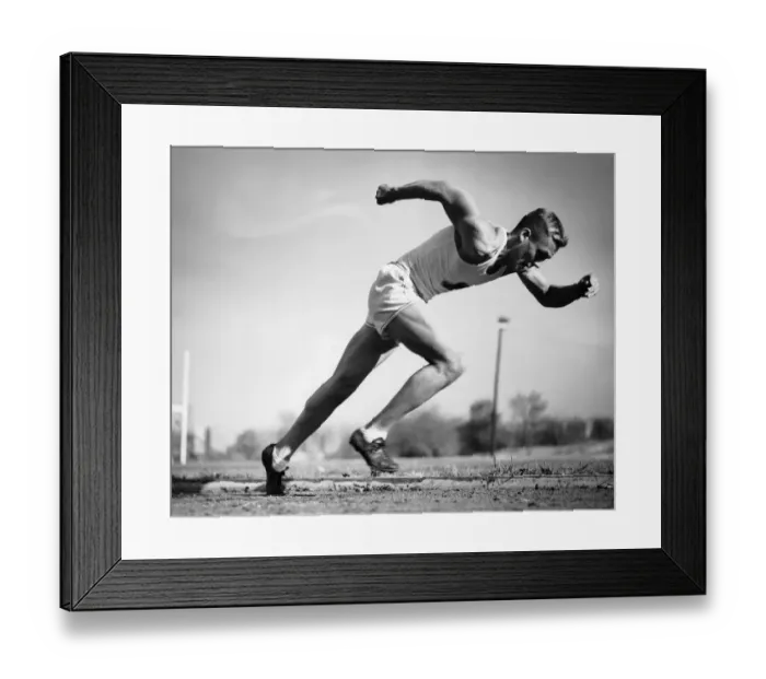 Framed Print : Male runner jumping from starting blocks at beginning of race Framed Print : Male runner jumping from starting blocks at beginning of race