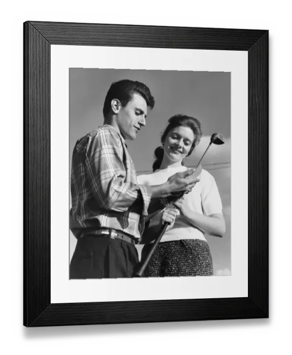 Framed Print : Man showing golf club to woman Framed Print : Man showing golf club to woman