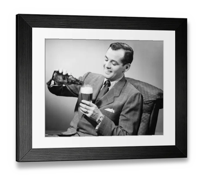 Framed Print : Elegant man pouring beer from bottle into glass, (B&W) Framed Print : Elegant man pouring beer from bottle into glass, (B&W)