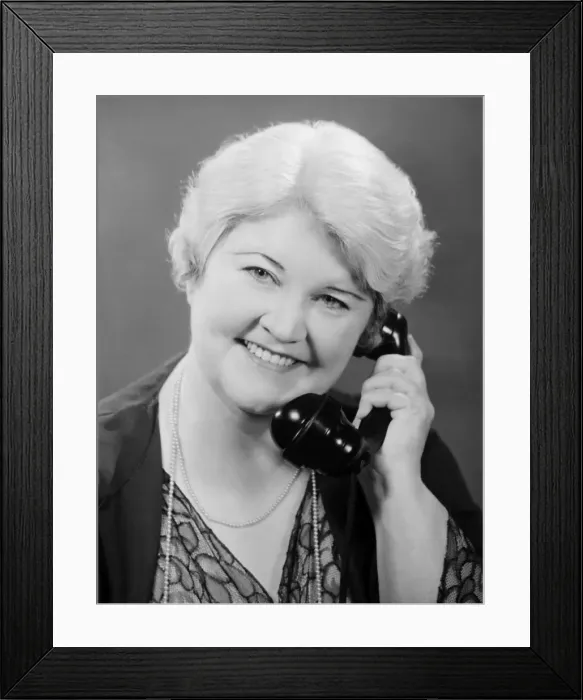 Framed Print : Well groomed mature woman talking on phone, (B&W), close-up, portrait Framed Print : Well groomed mature woman talking on phone, (B&W), close-up, portrait