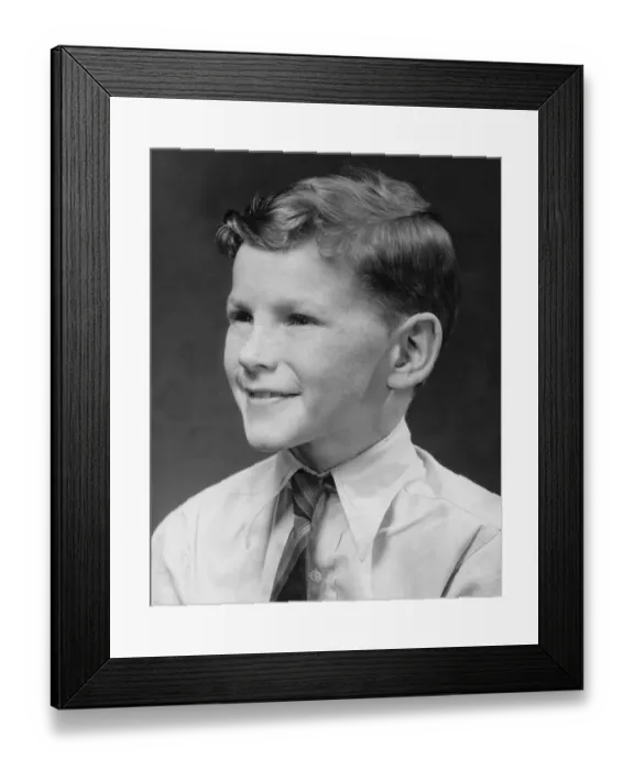 Framed Print : Boy (8-9) smiling, posing in studio, (B&W)
