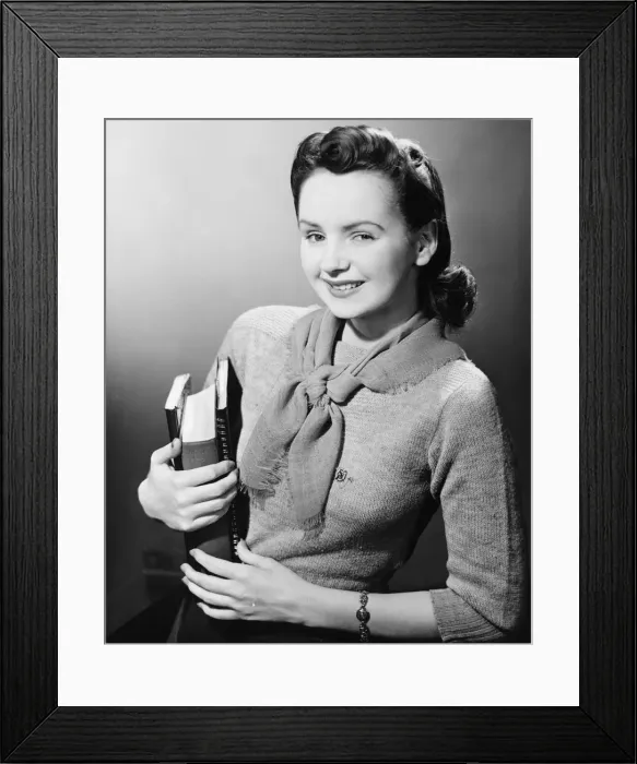 Framed Print : Young woman holding books, (B&W), portrait Framed Print : Young woman holding books, (B&W), portrait