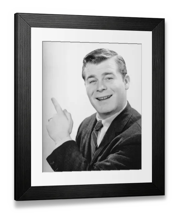 Framed Print : Man pointing with forefinger in studio, (B&W), close-up, portrait Framed Print : Man pointing with forefinger in studio, (B&W), close-up, portrait