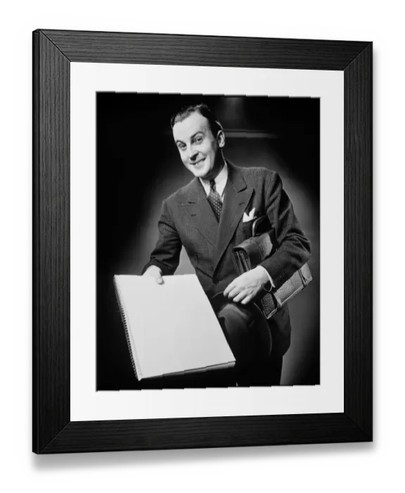 Framed Print : Businessman presenting notebook, (B&W), portrait Framed Print : Businessman presenting notebook, (B&W), portrait