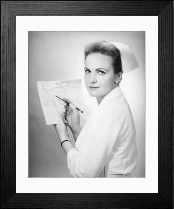 Framed Print : Nurse holding patients chart in studio, (B&W), portrait Framed Print : Nurse holding patients chart in studio, (B&W), portrait