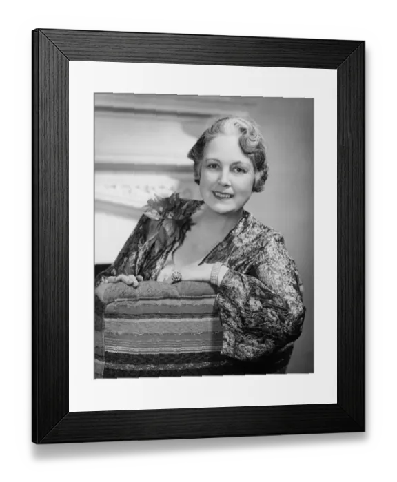 Framed Print : Woman sitting on couch, (B&W), close-up, portrait Framed Print : Woman sitting on couch, (B&W), close-up, portrait