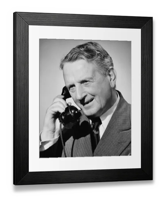 Framed Print : Senior man on phone, (B&W), close-up