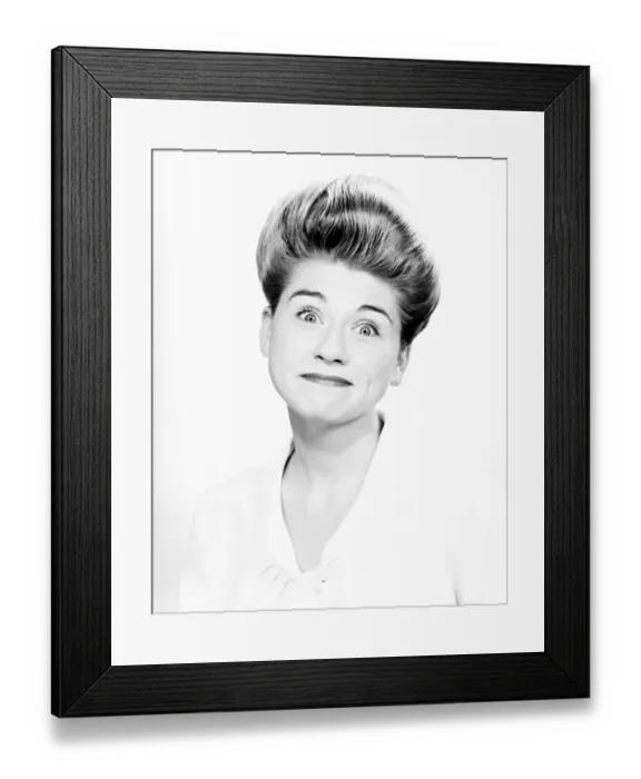 Framed Print : Woman with pompadour making face in studio, (B&W), close-up, portrait Framed Print : Woman with pompadour making face in studio, (B&W), close-up, portrait