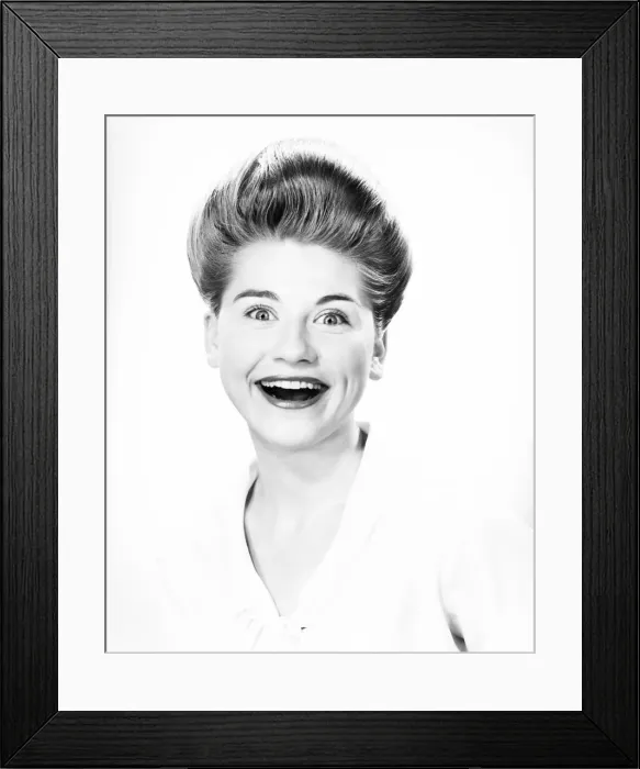 Framed Print : Woman with pompadour making face in studio, (B&W), close-up, portrait Framed Print : Woman with pompadour making face in studio, (B&W), close-up, portrait