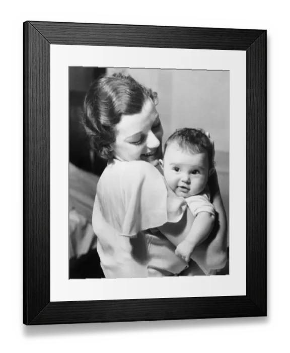 Framed Print : Young mother holding baby boy (9-12 months) in arms, (B&W) Framed Print : Young mother holding baby boy (9-12 months) in arms, (B&W)
