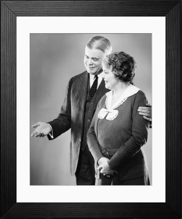 Framed Print : Couple standing side by side, talking, (B&W) Framed Print : Couple standing side by side, talking, (B&W)