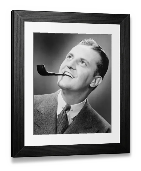 Framed Print : Businessman holding pipe in teeth, (B&W), close-up Framed Print : Businessman holding pipe in teeth, (B&W), close-up