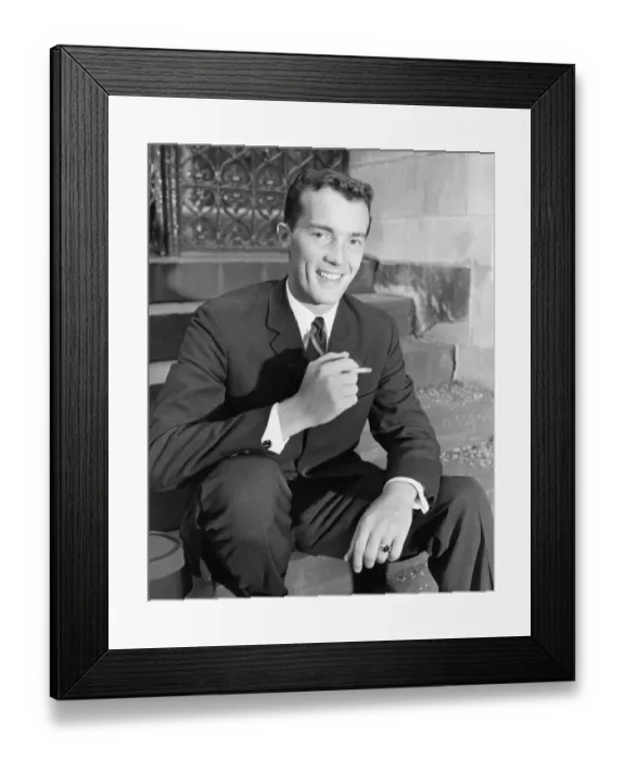 Framed Print : Young businessman sitting on steps, smoking cigarette, (B&W) Framed Print : Young businessman sitting on steps, smoking cigarette, (B&W)