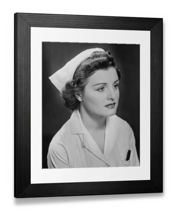 Framed Print : Young nurse sitting, looking away, (B&W)