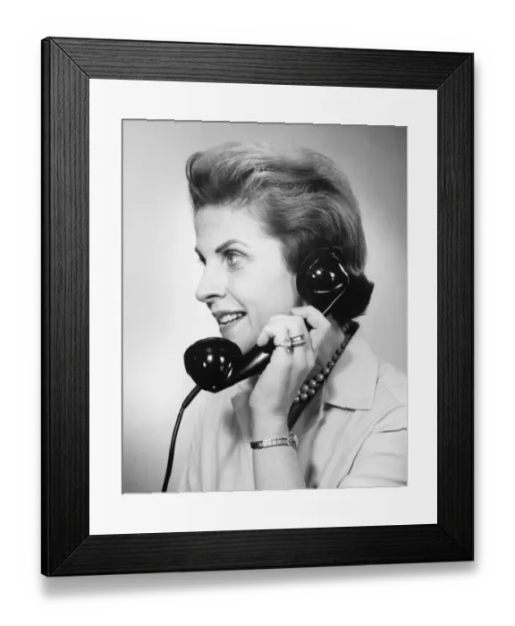 Framed Print : Woman using telephone, (B&W), close-up