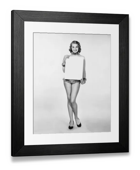 Framed Print : Woman in fur-trimmed leotard holding blank poster Framed Print : Woman in fur-trimmed leotard holding blank poster