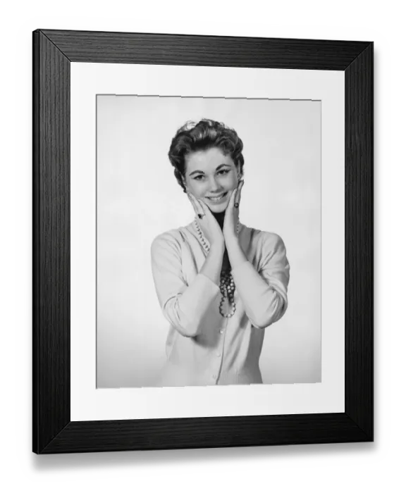 Framed Print : Woman touching face, looking surprised Framed Print : Woman touching face, looking surprised