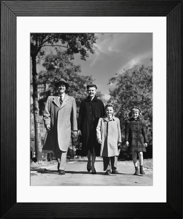 Framed Print : Family walking along street Framed Print : Family walking along street