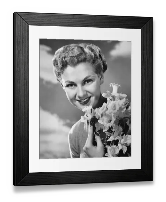 Framed Print : Woman holding bunch of daffodils Framed Print : Woman holding bunch of daffodils