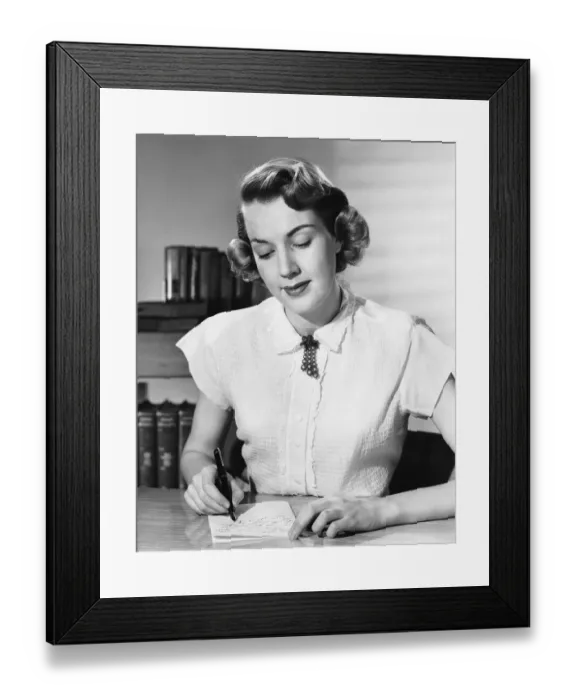 Framed Print : Woman sitting at desk, writing note Framed Print : Woman sitting at desk, writing note