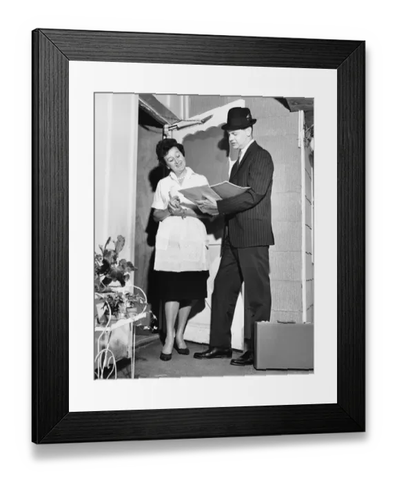 Framed Print : Woman listening to salesman in doorway Framed Print : Woman listening to salesman in doorway