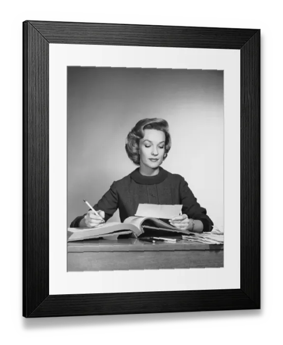Framed Print : Woman looking at paper, holding pencil Framed Print : Woman looking at paper, holding pencil