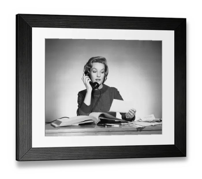 Framed Print : Woman using phone and looking at paper Framed Print : Woman using phone and looking at paper