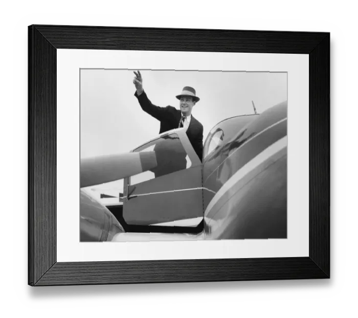Framed Print : Man waving, getting in plane Framed Print : Man waving, getting in plane