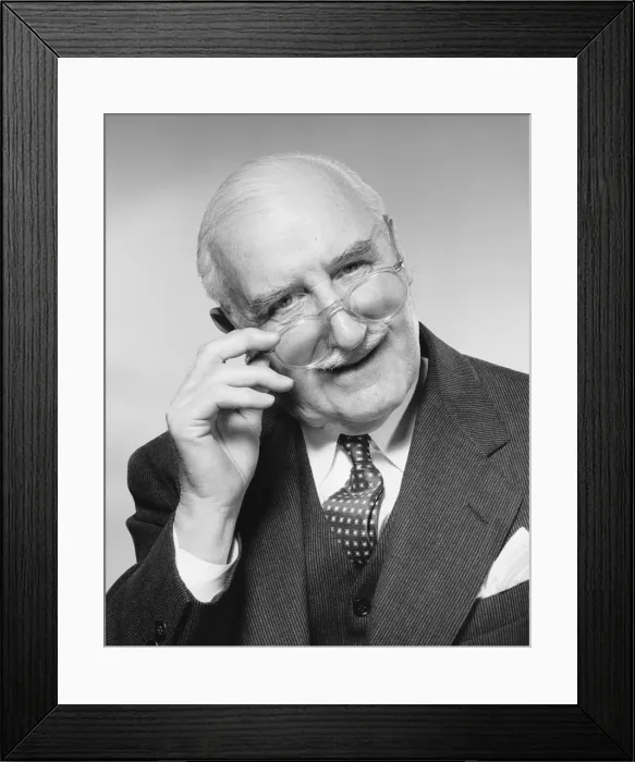 Framed Print : Man smiling, adjusting glasses Framed Print : Man smiling, adjusting glasses