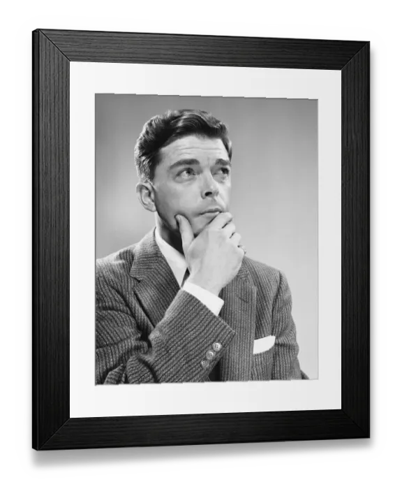 Framed Print : Man holding chin, looking upward Framed Print : Man holding chin, looking upward