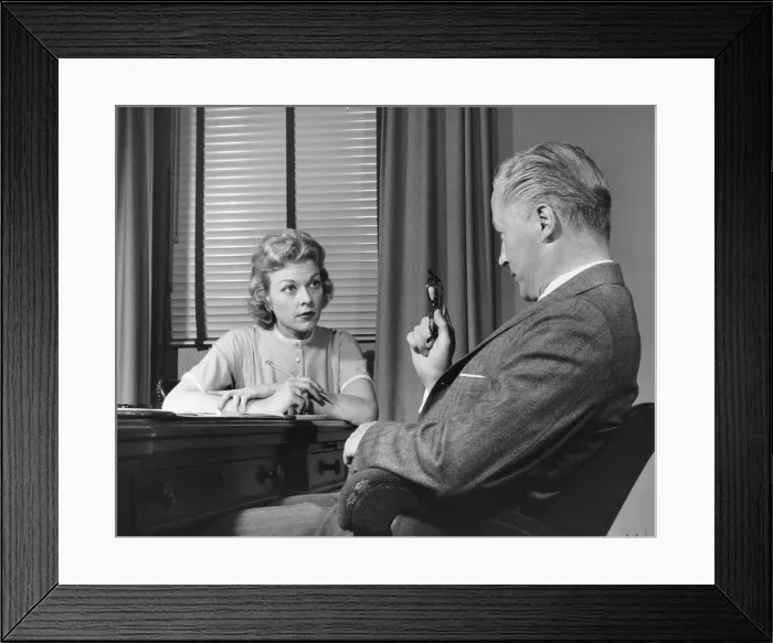Framed Print : Man talking to woman who is taking notes Framed Print : Man talking to woman who is taking notes
