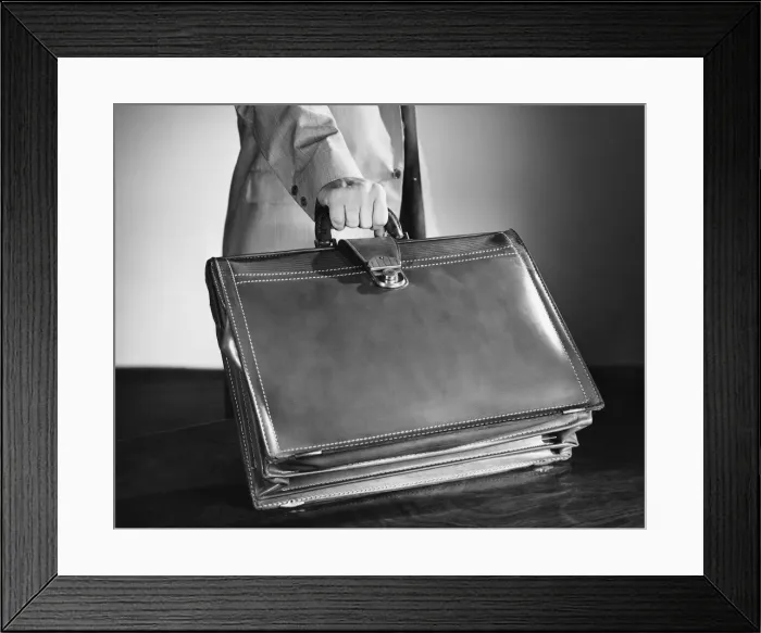 Framed Print : Hand shot of man picking up briefcase Framed Print : Hand shot of man picking up briefcase