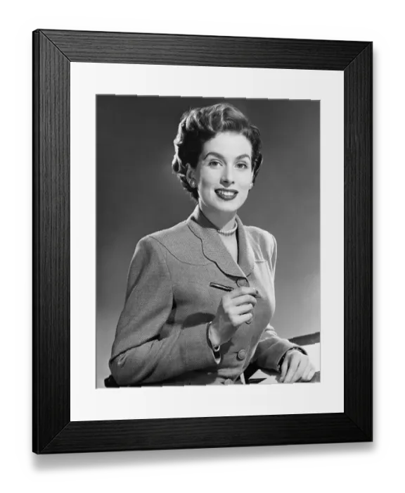 Framed Print : Woman smiling, holding pen Framed Print : Woman smiling, holding pen