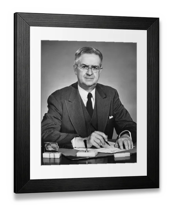 Framed Print : Man sitting at desk, holding pen
