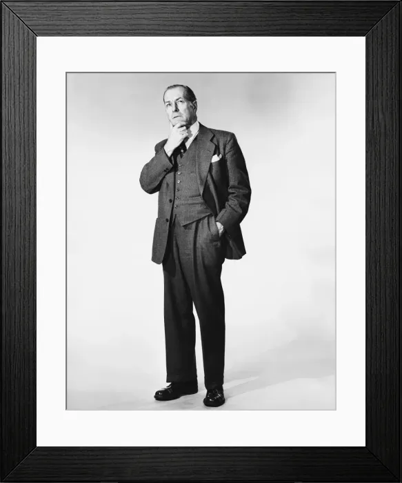 Framed Print : Man standing, rubbing chin Framed Print : Man standing, rubbing chin