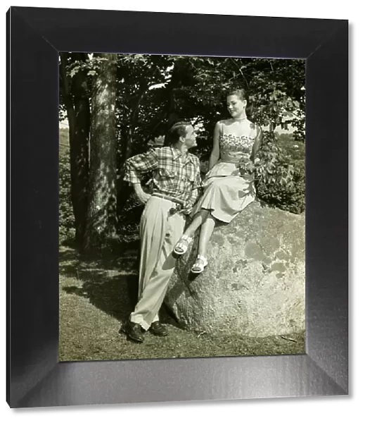 Young couple posing in park, (B&W)