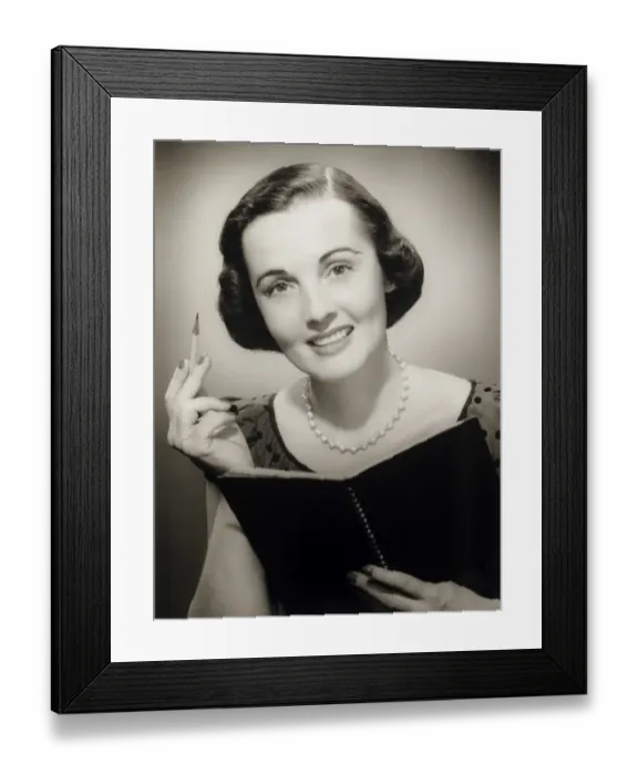 Framed Print : Woman holding pencil and notebook, posing in studio, (B&W), (Close-up), (Portrait) Framed Print : Woman holding pencil and notebook, posing in studio, (B&W), (Close-up), (Portrait)