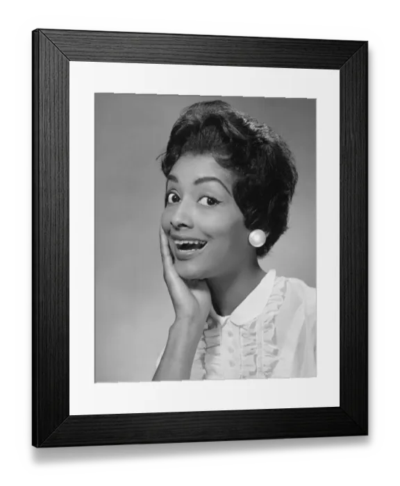 Framed Print : Woman with hand to face, looking surprised Framed Print : Woman with hand to face, looking surprised