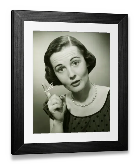 Framed Print : Woman with string tied around finger in studio, (B&W), (Close-up), (Portrait) Framed Print : Woman with string tied around finger in studio, (B&W), (Close-up), (Portrait)
