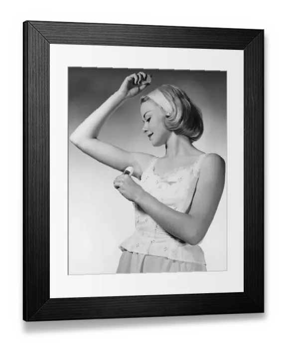 Framed Print : Woman putting on underarm deodorant Framed Print : Woman putting on underarm deodorant