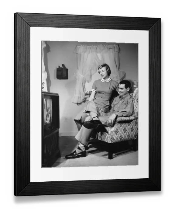 Framed Print : Husband and wife watching television Framed Print : Husband and wife watching television