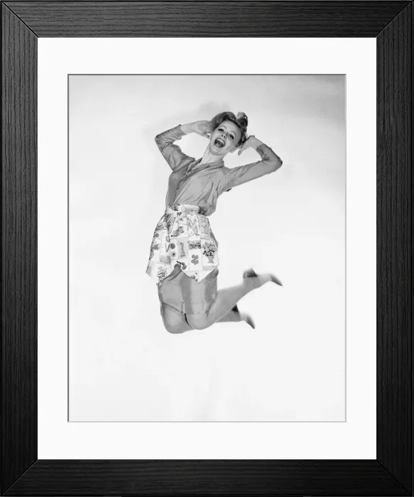 Framed Print : Woman wearing apron, jumping Framed Print : Woman wearing apron, jumping