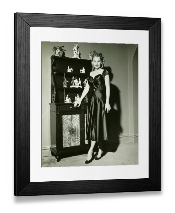 Framed Print : Woman in evening gown posing at cabinet, (B&W), (Portrait) Framed Print : Woman in evening gown posing at cabinet, (B&W), (Portrait)