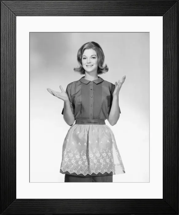 Framed Print : Woman wearing apron, gesturing Framed Print : Woman wearing apron, gesturing