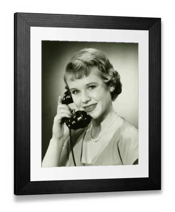 Framed Print : Woman on phone posing in studio, (B&W), (Close-up), (Portrait) Framed Print : Woman on phone posing in studio, (B&W), (Close-up), (Portrait)