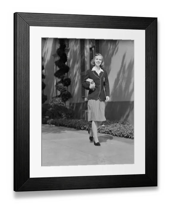 Framed Print : Female student walking outside school, portrait